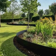 Powder Coated Steel edging in a curved shape separating grass from a flowerbed