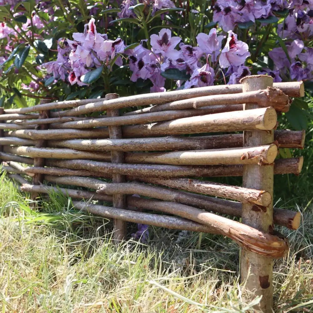 Woven hazel hurdles forming a soft boundary between the park and the neighbouring lane.
